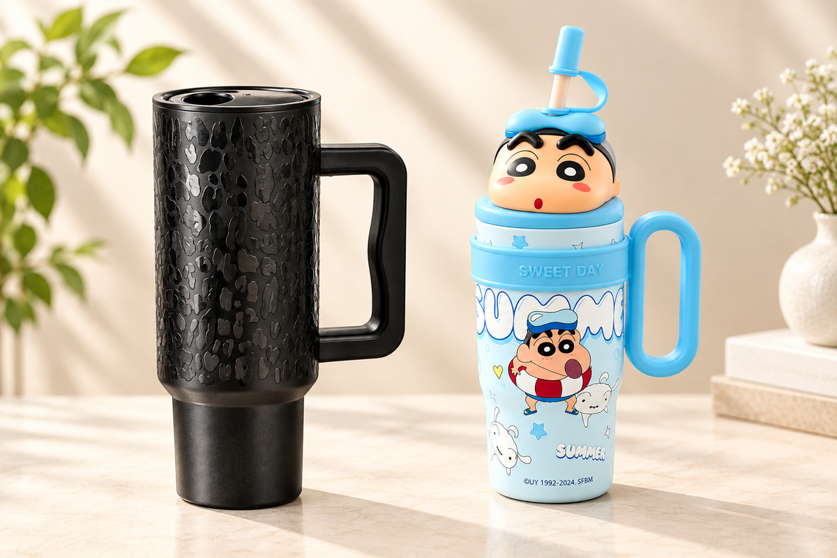 REYLVA black textured 1180ML tumbler and blue cartoon 800ML kids tumbler with handles on an ivory tabletop